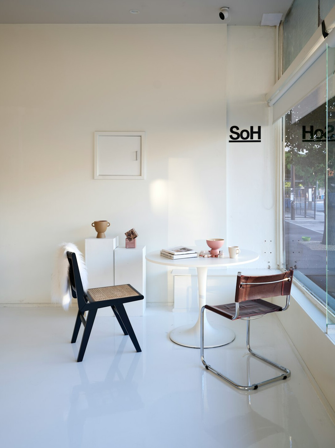 Bright training studio reception with monitors and sofa